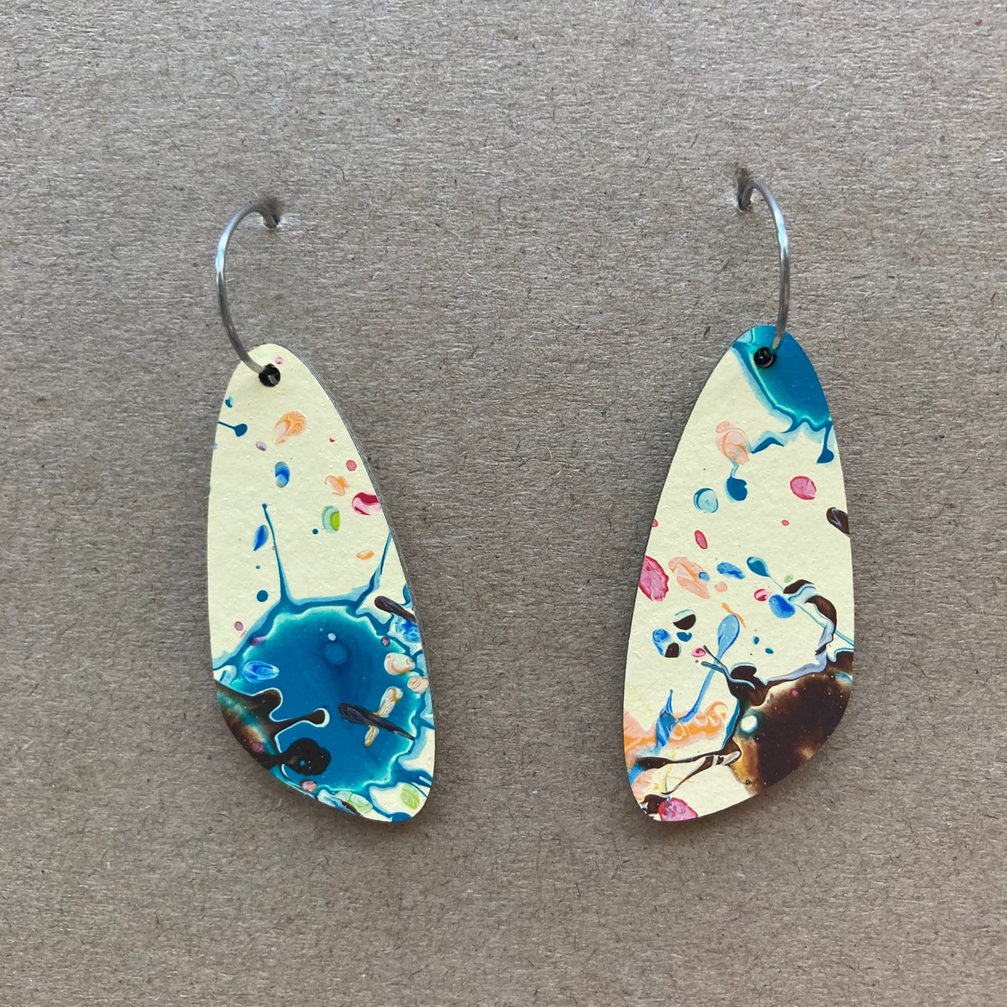 Cream dangles with blue speckles