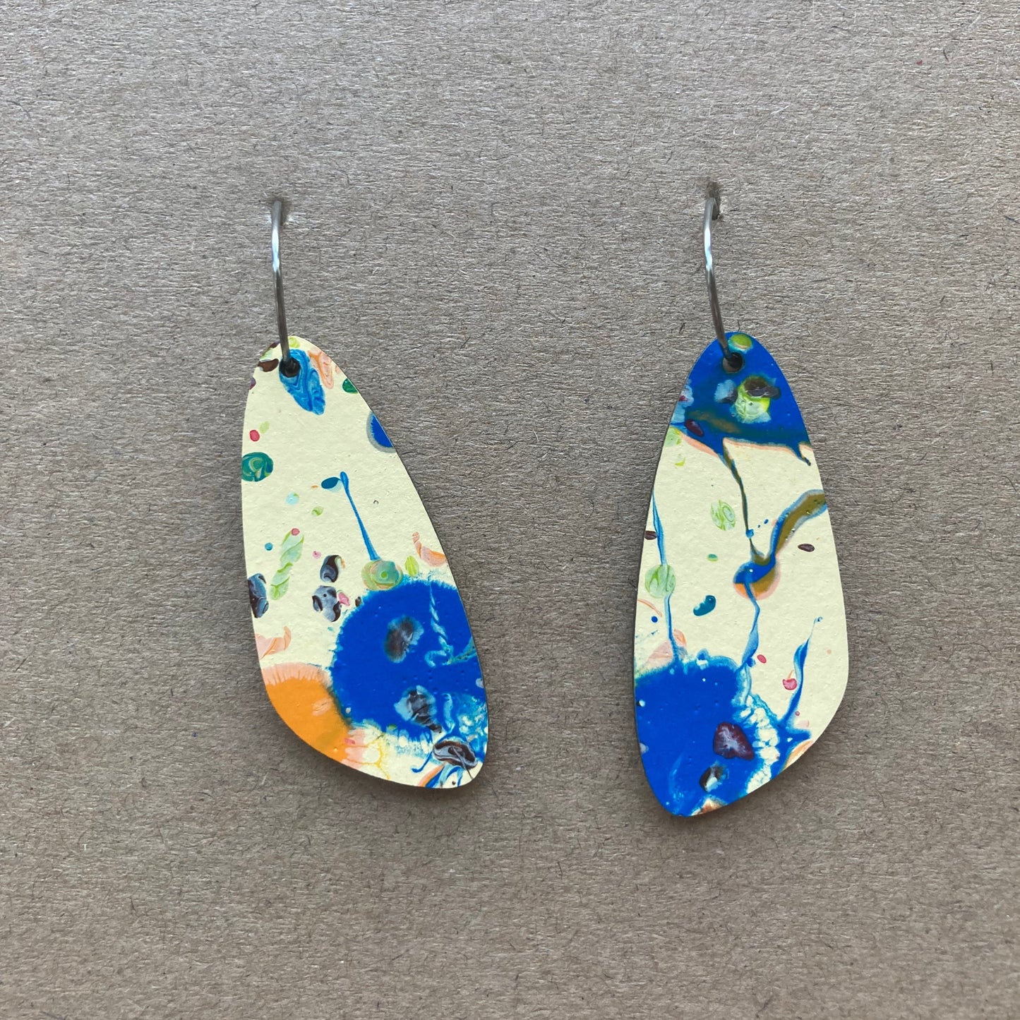 Cream dangles with blue speckles